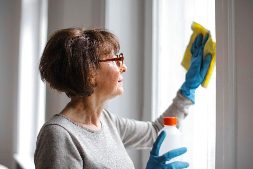 Woman using glass cleaner